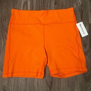Athleta NWT "ultimate stash pocket 7" short" in lovely orange color!